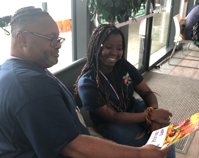 a man and a younger lady with a leaflet about hope college