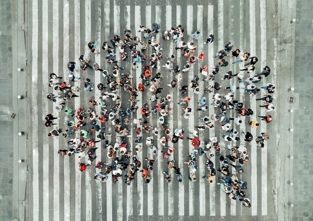 Top down view of people stood in the shape of a speech bubble